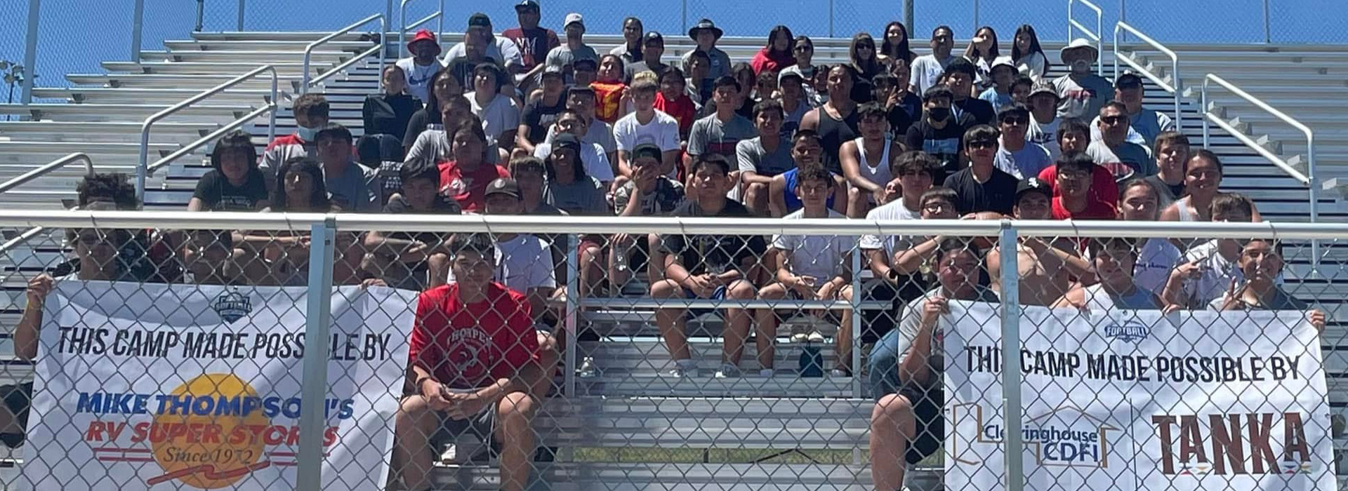 Football for Life camp attendees in the bleachers